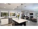 Bright, modern kitchen with marble island and stainless steel appliances open to the living space at 943 E Kortsen Rd # 10, Casa Grande, AZ 85122