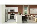 Modern kitchen with stainless steel appliances and a center island at 9830 W Pinchot Ave, Phoenix, AZ 85037