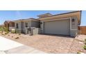 Single-story home features a well-maintained front yard, two-car garage, and a secure gated entryway at 11015 E Texas Ave, Mesa, AZ 85212