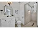 Modern bathroom features a tiled shower with rainfall shower head and updated vanity at 132 W Orchid Ln, Chandler, AZ 85225
