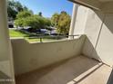 Balcony with view of the manicured lawn and mature trees providing a private and relaxing outdoor area at 1825 W Ray Rd # 2082, Chandler, AZ 85224