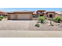 Beautiful desert home featuring a two-car garage, brick paver driveway, and xeriscaping at 19745 N Mountain Sage Ln, Surprise, AZ 85374