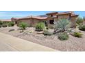 Inviting single-Gathering home featuring xeriscaping, desert plants, and a clay tile roof at 19745 N Mountain Sage Ln, Surprise, AZ 85374