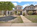 Inviting two-story home with a charming front yard and walkway at 3036 N Acacia Way, Buckeye, AZ 85396