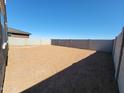 An expansive backyard with block fencing, perfect for outdoor activities and privacy at 37386 W San Sisto Ave, Maricopa, AZ 85138