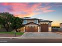 Charming two-story home featuring a three-car garage, desert landscaping, and solar panels at 3944 W Paradise Ln, Phoenix, AZ 85053