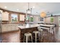 Bright kitchen featuring brick accent wall, modern appliances, a large island and eating area at 3944 W Paradise Ln, Phoenix, AZ 85053