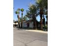 Cozy single-story home with a red front door and mature palm trees at 404 W 11Th St, Tempe, AZ 85281