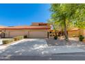 Charming home featuring a three-car garage, tile roof, mature trees, and a low-maintenance desert landscape at 4772 W Joshua Blvd, Chandler, AZ 85226