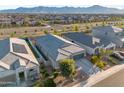 Overhead shot of a neighborhood showcasing homes with desert landscaping and mountain views at 5345 W Alta Mesa Ave, Laveen, AZ 85339