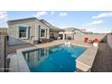 Backyard pool and patio featuring lounge chairs and covered seating, perfect for relaxation at 5345 W Alta Mesa Ave, Laveen, AZ 85339