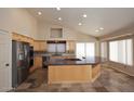 Bright, open kitchen with stainless steel appliances and a large center island at 6023 E Scafell Cir, Mesa, AZ 85215