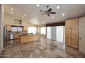 Open kitchen with stainless steel appliances, large island, and ample cabinet space at 6023 E Scafell Cir, Mesa, AZ 85215