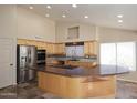 Spacious kitchen with stainless steel appliances, cooktop, and a large center island at 6023 E Scafell Cir, Mesa, AZ 85215