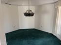 Dining room with hanging light fixture, neutral walls and standard window at 6320 W Del Mar Ln, Glendale, AZ 85306