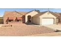 Charming single-story home with a two-car garage and low-maintenance desert landscaping in front at 6320 W Del Mar Ln, Glendale, AZ 85306