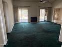 Bright living room with fireplace, sliding doors, and lots of natural light at 6320 W Del Mar Ln, Glendale, AZ 85306