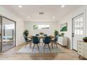 Bright dining room with a modern table and chairs, plus sliding glass doors to the outdoor patio at 6813 E Diamond St, Scottsdale, AZ 85257
