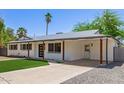 Inviting single-story home with a covered carport, low-maintenance landscaping, and an attractive modern door at 6813 E Diamond St, Scottsdale, AZ 85257