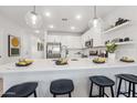 Open concept kitchen with a large center island, stainless steel appliances, and pendant lighting at 7439 S 76Th Dr, Laveen, AZ 85339