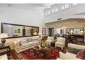 Elegant living room with a vaulted ceiling, fireplace, and sophisticated decor at 7955 E Chaparral Rd # 129, Scottsdale, AZ 85250