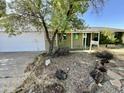 Charming single-story home with xeriscape landscaping and mature tree in front yard at 8257 E Cypress St, Scottsdale, AZ 85257
