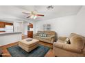 Comfortable living room featuring neutral sofas, a ceiling fan, and an open view to the kitchen at 9431 E Coralbell Ave # 192, Mesa, AZ 85208