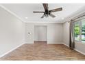 Open living room features wood-look floors, recessed lighting, and a ceiling fan at 1050 W 9Th Pl, Mesa, AZ 85201