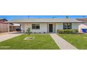 Charming single-story home boasts a manicured lawn and inviting brick pathway to the front door at 1058 E 2Nd St, Mesa, AZ 85203