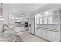 Bright, modern kitchen with white cabinetry, granite countertops, and stainless steel appliances at 11342 E Laguna Azul Cir, Mesa, AZ 85209