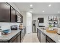 Bright kitchen with granite countertops, stainless steel appliances, and a central island with bar seating at 1162 S Mullberry St, Florence, AZ 85132