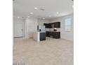 Open-concept living space with tile flooring adjoining the kitchen and leading to the front entrance at 1373 S Vista Ave, Florence, AZ 85132