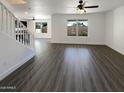 Spacious open-concept living room with wood-look floors and staircase at 1400 S Crossbow Ct, Chandler, AZ 85286
