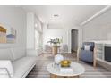 Bright living room with hardwood floors, white walls, and modern furnishings at 16818 S 23Rd St, Phoenix, AZ 85048