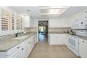 Well-lit kitchen featuring granite countertops, white cabinets, and modern appliances, perfect for cooking and entertaining at 19120 N 98Th Ln, Peoria, AZ 85382