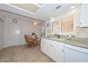 Cozy breakfast nook in kitchen, featuring granite countertops and white cabinets at 19120 N 98Th Ln, Peoria, AZ 85382