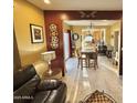 Open floor plan featuring tile flooring, dark wood accents, and views into the dining and kitchen at 2014 N 17Th Pl, Phoenix, AZ 85006