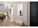Bright entryway with hardwood floors, high ceilings, and a view into the living room at 21105 N 37Th Run, Phoenix, AZ 85050