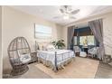 A serene bedroom features a cozy wicker chair and beach themed decor at 2129 E Beautiful Ln, Phoenix, AZ 85042