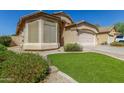 Charming single-story home featuring a two-car garage and a well-maintained landscaped front yard at 29049 N Coal Ave, San Tan Valley, AZ 85143