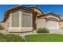 Charming single-story home featuring a two-car garage and a well-maintained landscaped front yard at 29049 N Coal Ave, San Tan Valley, AZ 85143