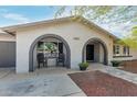 A single-Gathering home showing a front porch with chairs, manicured flowerpots, and excellent curb appeal at 3061 W Betty Elyse Ln, Phoenix, AZ 85053