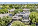 Aerial view of a home with solar panels, surrounded by lush greenery and mature trees in a residential neighborhood at 3062 E Cullumber St, Gilbert, AZ 85234