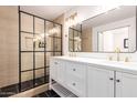 Bathroom with a large mirror, double vanity, and a glass enclosed shower with black grid accents at 3150 E Beardsley Rd # 1081, Phoenix, AZ 85050