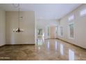 Expansive living room featuring a chandelier, marble flooring, neutral palette, and lots of natural light at 32710 N 71St St, Scottsdale, AZ 85266