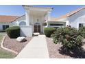 Inviting front entrance featuring decorative shrubbery and desert landscaping at 3314 E Draper Cir, Mesa, AZ 85213