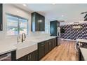 Beautiful kitchen featuring sleek cabinetry, a farmhouse sink, stainless steel appliances, and quartz countertops at 3344 N 62Nd Pl, Scottsdale, AZ 85251