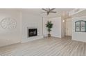 Open living room featuring modern flooring, a cozy fireplace, and ample natural light at 4933 E Downing St, Mesa, AZ 85205