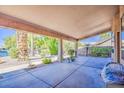 Spacious covered patio with concrete flooring and views of the lush backyard landscape at 694 W Beechnut Dr, Chandler, AZ 85248