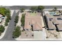 Overhead view of the property featuring a landscaped backyard, a neat lawn, mature trees, and a private swimming pool at 8068 W Carlota Ln, Peoria, AZ 85383